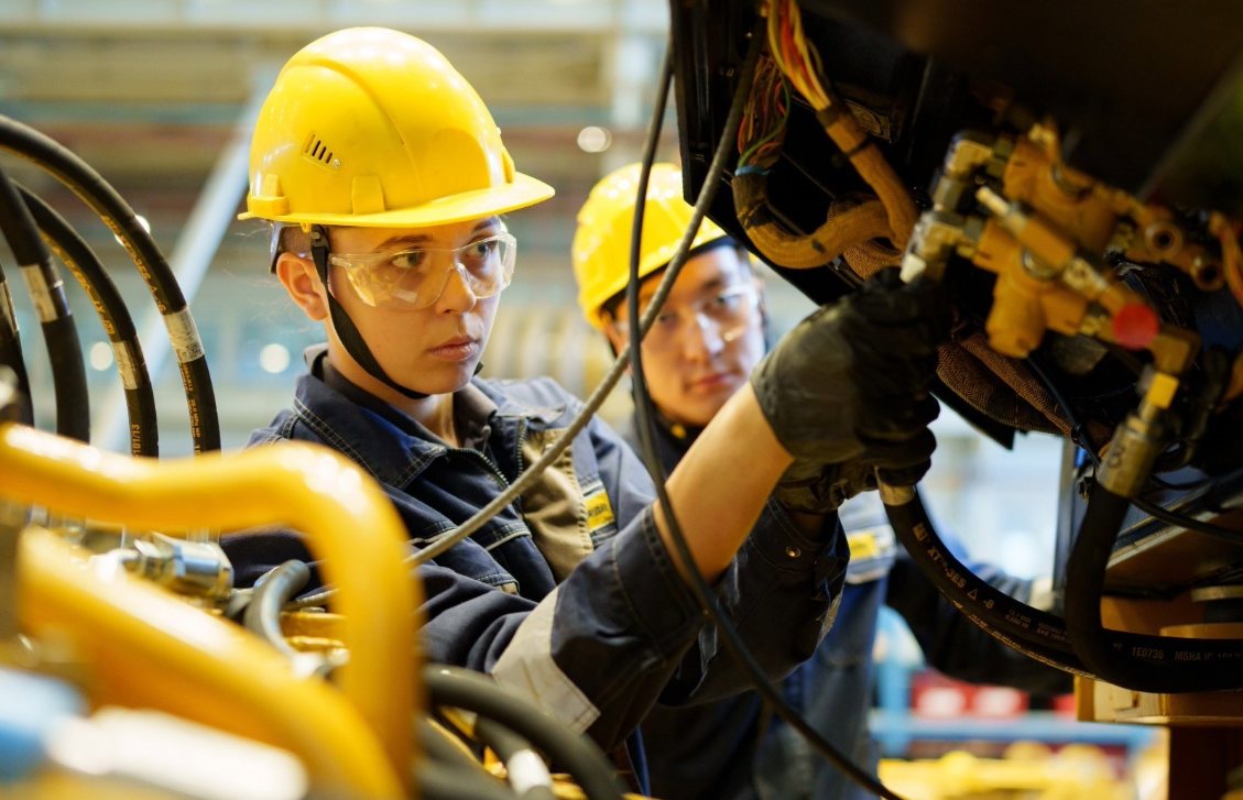 two factory workers wearing protective clothing