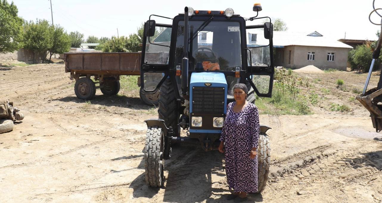 Ms. Baymuradova, a GEFF sub-borrower and loan beneficiary, with her new fuel-efficient tractor